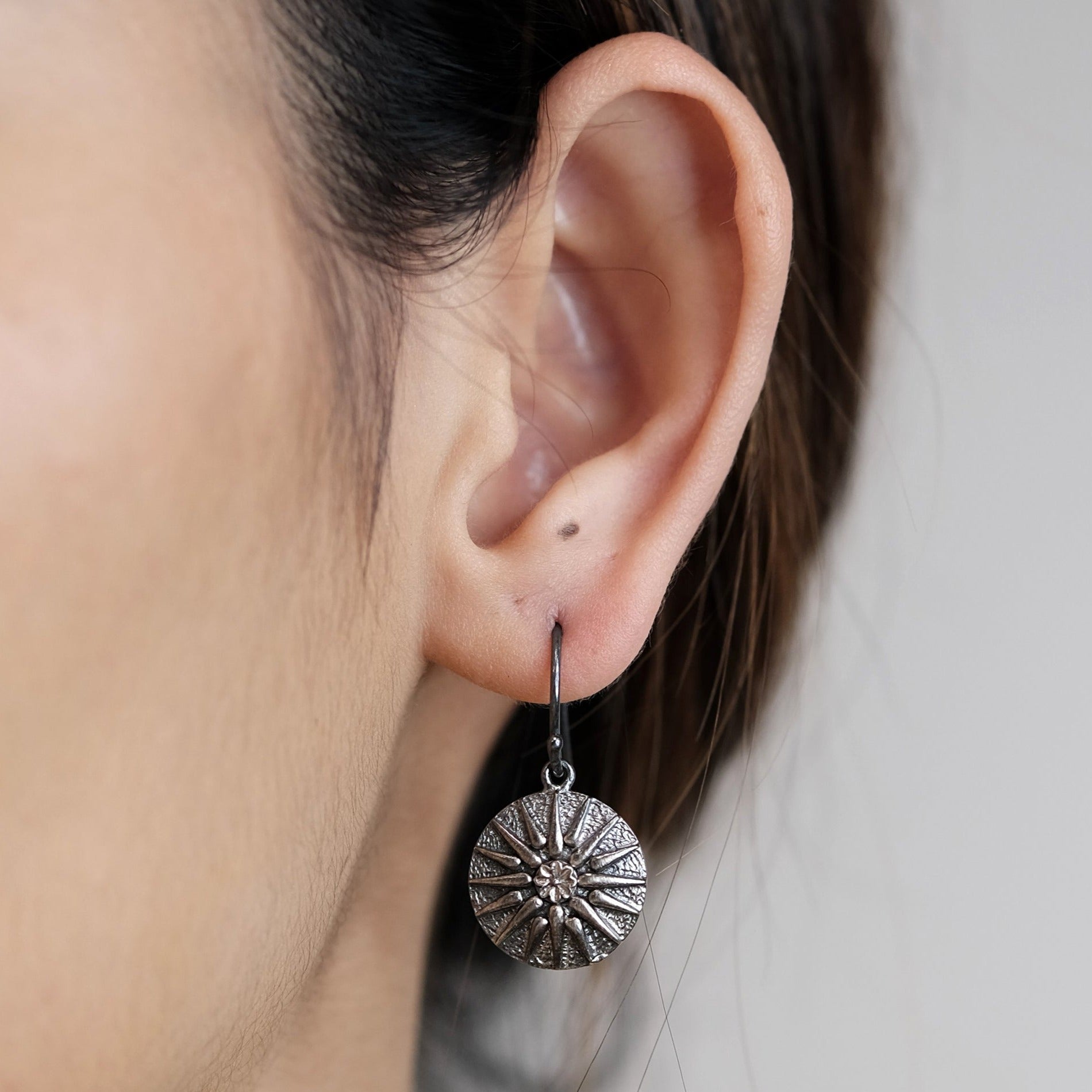 The Madstone star compass earrings