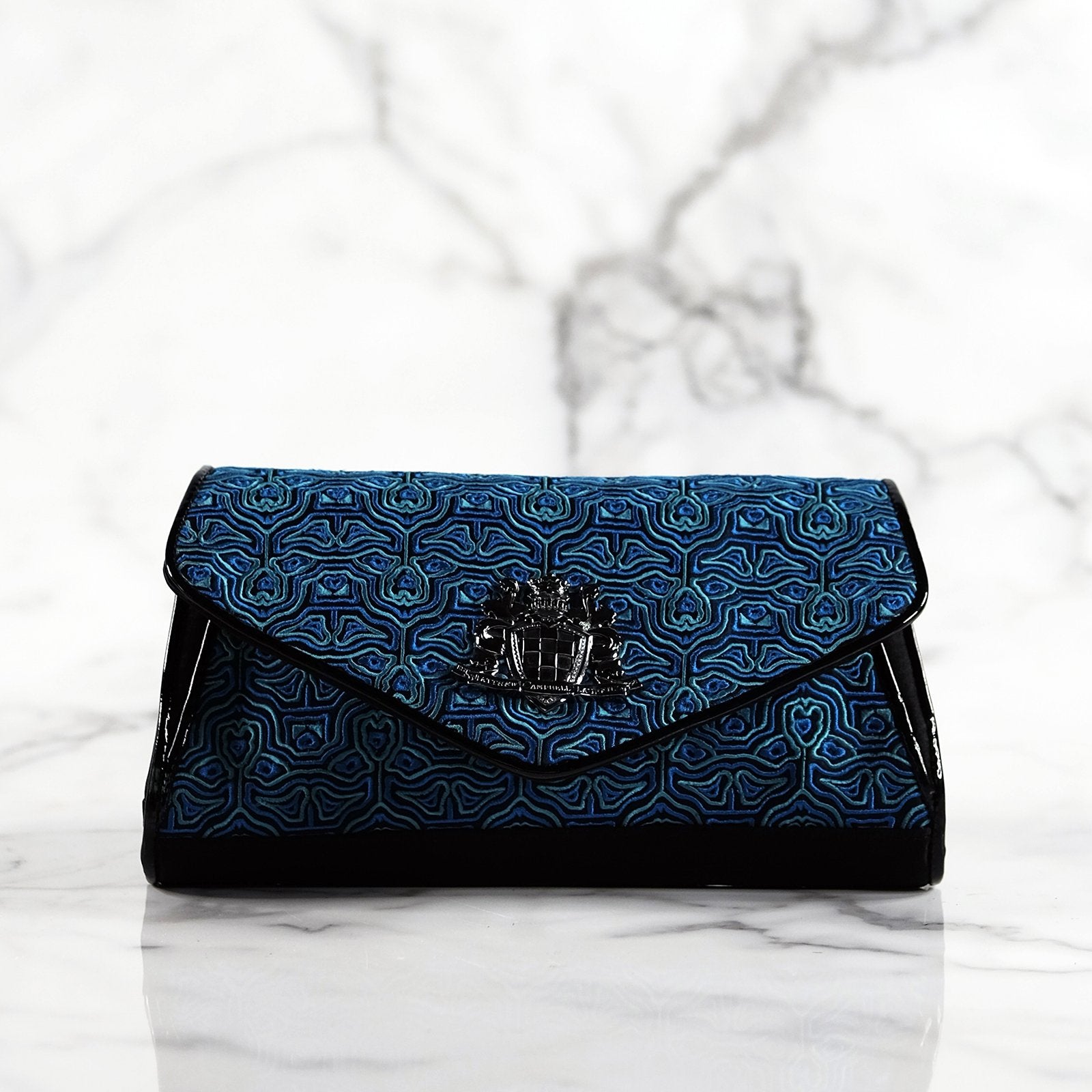 Tasja ocean blues and black embroidered satin and piped leather handbag with sequins